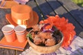 Baking and various foods and drinks for lunch on the nature. Oranjevaya hat and accessories. Traditional donuts for King`s Day Royalty Free Stock Photo