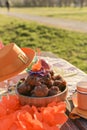 Baking and various foods and drinks for lunch on the nature. Oranjevaya hat and accessories. Traditional donuts for King`s Day Royalty Free Stock Photo