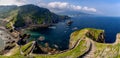 Long and winding stone stairs leading up to the Church of San Juan de Gaztelugatxe with a view of the coast of the Spanish Basque