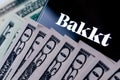 Bakkt and money. Bakkt is a digital assets custody service, known for Bakkt Bitcoin Futures contracts trading. Conceptula photo.