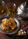 Baklava or baklawa. Ramadan Dessert. Traditional Arabic dessert with pistachios, honey and mint tea on dark surface, selective Royalty Free Stock Photo