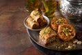 Baklava or baklawa. Ramadan Dessert. Traditional Arabic dessert with pistachios, honey and mint tea on dark surface Royalty Free Stock Photo