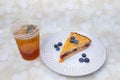 Baklava cheesecake with blueberry toppings and iced tea on the side