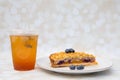 Baklava cheesecake with blueberry toppings and iced tea on the side Royalty Free Stock Photo