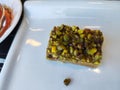 Baklava dessert with plenty of pistachios. catering presentation photo.