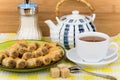 Baklava ion plate, sugar bowl and tea on tablecloth