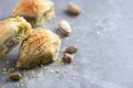 Baklava with pistachios on grey background. Jewish, turkish, arabic traditional national dessert. Macro. Selective focus Royalty Free Stock Photo