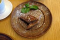 Baklava with walnuts on a clay plate top view.