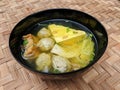 Bakso or indonesian meatball in a black bowl, a soupy dish from Indonesia