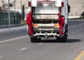 Garbage collection service, A waste collector working on emptying garbage cans for garbage collection with waste loading on a truc