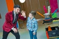 An illusionist and kids is holding a dove in his hands. The magician shows a performance . Focus-illusionist shows children