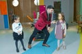 An illusionist and kids is holding a dove in his hands. The magician shows a performance . Focus-illusionist shows children