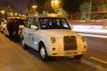 White Baku taxi `London Taxi TX4` waiting for passengers in the evening twilight
