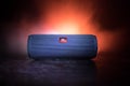 BAKU. AZERBAÃÂ°JAN Ã¢â¬â 28.07.2020: JBL Flip 4 Bluetooth Speaker close up shot on wooden table with colorful lights and fog on