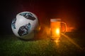 BAKU,AZERBAIJAN - JUNE 23, 2018 : Official Russia 2018 World Cup football ball The Adidas Telstar 18 and single beer glass on gree Royalty Free Stock Photo