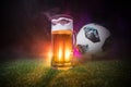 BAKU,AZERBAIJAN - JUNE 23, 2018 : Official Russia 2018 World Cup football ball The Adidas Telstar 18 and single beer glass on gree Royalty Free Stock Photo