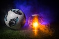 BAKU,AZERBAIJAN - JUNE 23, 2018 : Official Russia 2018 World Cup football ball The Adidas Telstar 18 and single beer glass on gree