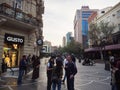 Group of people in central square talking, smoking eating meeting near the Gusto