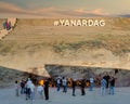 Yanar Dag burning mountain in Azerbaijan, showing flames emerging from ground, with the sign Yanar Dag in the far end