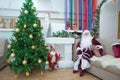 New Year celebration in Azerbaijan kindergarten with Ded Moroz Grandfather Frost . The child takes a photo with Santa Claus.