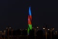 Flame Fountain building is illuminated by the colors of the Azerbaijan flag. Night view