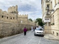 Baku, Azerbaijan, September, 09, 2019. Fortress wall of Baku fortress and  Muse art cafe on Kichik Gala street in the old city of Royalty Free Stock Photo