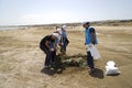 BAKU,AZERBAIJAN- 24 SEPTEMBER 2018 : Group of young students helping one another to clean up the beach, safe ecology