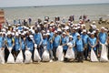 BAKU,AZERBAIJAN- 24 SEPTEMBER 2018 : Group of young students helping one another to clean up the beach, safe ecology