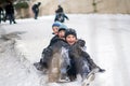 Boys sledding in a snowy . Children ski in the snow . The children were very happy and laughing . Two very happy caucasian kids Royalty Free Stock Photo