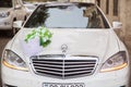 A white car caught for a wedding . White luxury cars parked in luxury district near pretty houses . Baku, Azerbaijan 12.04.2017