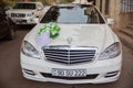 A white car caught for a wedding . White luxury cars parked in luxury district near pretty houses . Baku, Azerbaijan 12.04.2017