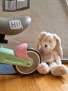 Balance bike wheel and a toy. Bunny rabbit toy and a toddlers bike. Teepee tent in the background. Kids playroom