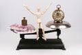 A balance compares the weight of money with the weight of time, job versus leisure time, time is money