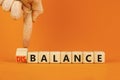 Balance or disbalance symbol. Concept word Disbalance or Balance on beautiful wooden cubes. Beautiful orange background.