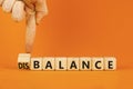 Balance or disbalance symbol. Concept word Disbalance or Balance on beautiful wooden cubes. Beautiful orange background.