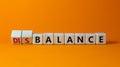 Balance or disbalance symbol. Turned cubes and changed the word disbalance to balance. Beautiful orange background, copy space.