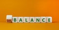 Balance or disbalance symbol. Turned cubes and changed the word disbalance to balance. Beautiful orange background, copy space.