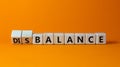 Balance or disbalance symbol. Turned cubes and changed the word disbalance to balance. Beautiful orange background, copy space.