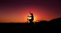 Balance, Enjoying Life and Harmony Concept. Silhouette of Happiness Person on Bicycle with raised arms to Balancing Body during Royalty Free Stock Photo