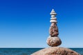 Balance and poise stones against the sea. Rock zen on the background of blue sky.