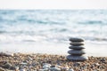 Balance pyramid of spa stones on natural blurred background.