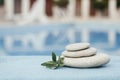 Balance pyramid of spa stones on natural blurred background.