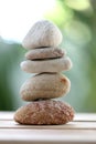 Balance rock or zen stones on wooden floor and have nature green Royalty Free Stock Photo