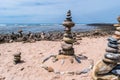 Balance of several stones of different sizes in stack in sand by the sea at Farol beach in Milfontes, Vicentine Coast Natural Park