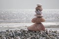 Balance stone on pile rock with sea background.