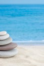 Balance stones pebbles stack pyramid for relaxation meditation with sea or ocean waves on background for vertical wallpaper Royalty Free Stock Photo