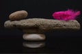 Balance with stones and red feather