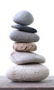 Balance Stones stacked placed on a wooden floor.