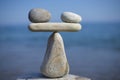 Balance of stones. To weight pros and cons. Balancing stones on the top of boulder. Close up. Royalty Free Stock Photo