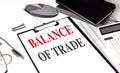 BALANCE OF TRADE text on clipboard on chart with notebook and calculator Royalty Free Stock Photo